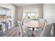 Bright dining area with a modern table set and a sliding glass door to the outdoor area at 4601 Copper Ln, Plant City, FL 33566