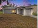 Charming single-story home featuring a one-car garage, neutral stucco, and an arched entryway with manicured lawn at 4601 Copper Ln, Plant City, FL 33566