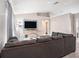 Spacious living room featuring a large sectional sofa and modern entertainment center with mounted TV at 4601 Copper Ln, Plant City, FL 33566