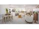 Open-concept living space features contemporary furnishings and seamless flow to kitchen and dining areas at 25298 Jubal St, Punta Gorda, FL 33955
