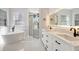 Bathroom features a soaking tub, glass shower, and double sink vanity with LED mirrors at 11019 Pine Lilly Pl, Lakewood Ranch, FL 34202