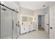 Bathroom features double sink vanity with LED mirrors and a glass shower at 11019 Pine Lilly Pl, Lakewood Ranch, FL 34202