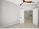 Neutral bedroom with ceiling fan, vinyl floors, and a doorway leading to another area at 11019 Pine Lilly Pl, Lakewood Ranch, FL 34202