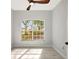 Bright bedroom with vinyl floors, a ceiling fan, and a large window overlooking greenery at 11019 Pine Lilly Pl, Lakewood Ranch, FL 34202
