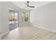 Bedroom with sliding glass door access to the patio and ceiling fan at 11019 Pine Lilly Pl, Lakewood Ranch, FL 34202
