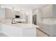 Modern kitchen features white cabinets, stainless steel appliances, and marble countertops at 11019 Pine Lilly Pl, Lakewood Ranch, FL 34202