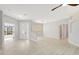 Bright, open-concept living area featuring luxury vinyl floors and a view of the front entrance at 11019 Pine Lilly Pl, Lakewood Ranch, FL 34202