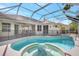 Beautiful pool and spa area enclosed in a screened lanai, with a clear view of the home's exterior at 11019 Pine Lilly Pl, Lakewood Ranch, FL 34202
