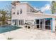 Back exterior of home showing patio area, grill, pool and damage to exterior wall at 11120 5Th E St, Treasure Island, FL 33706