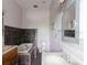 Bathroom featuring a tub, toilet, double vanity and large mirror at 11120 5Th E St, Treasure Island, FL 33706