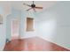 Bedroom with ceiling fan, wood floors and an outdoor entrance at 11120 5Th E St, Treasure Island, FL 33706