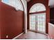 Hallway with vaulted ceilings with arched windows, and double doors that lead to outdoor scenery at 11120 5Th E St, Treasure Island, FL 33706
