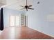 Bright and open-concept living room with hardwood floors, a built-in bookshelf, and large sliding glass door at 11120 5Th E St, Treasure Island, FL 33706