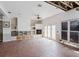 Spacious living room featuring tile flooring, a fireplace, and double doors to the outside at 11120 5Th E St, Treasure Island, FL 33706