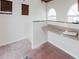 Office area with built-in desk, ceramic tile floors and two windows at 11120 5Th E St, Treasure Island, FL 33706