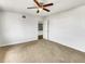 Bedroom with neutral carpet, fan and an open door to another room at 1115 31St W St, Bradenton, FL 34205