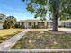 Charming single-story home features a well-maintained lawn, classic design, and inviting walkway at 1115 31St W St, Bradenton, FL 34205