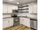 Stylish kitchen features white cabinets, stainless steel appliances and modern shelving at 1115 31St W St, Bradenton, FL 34205