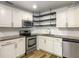 Updated kitchen features stainless steel appliances, white cabinets, and open shelving at 1115 31St W St, Bradenton, FL 34205