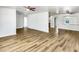 Open-concept living area with hardwood floors, ceiling fans, and plenty of natural light at 1115 31St W St, Bradenton, FL 34205