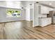 Open-concept living space featuring sleek wood floors, bright lighting and an adjacent kitchen area at 1115 31St W St, Bradenton, FL 34205