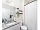 Bright bathroom featuring granite counters, a white vanity, and well-organized shelves with charming decor at 13532 Palmera Vista Dr, Riverview, FL 33579