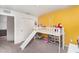 Bright bedroom features a unique loft bed with slide and fun yellow wall, creating a playful and inviting space at 13532 Palmera Vista Dr, Riverview, FL 33579