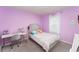Charming bedroom painted in a soothing lavender shade, complete with a desk and chair for study or creativity at 13532 Palmera Vista Dr, Riverview, FL 33579