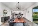 Open dining area with modern lighting fixture and access to the kitchen and outdoor patio at 13532 Palmera Vista Dr, Riverview, FL 33579