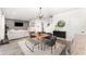 Bright dining area features modern lighting, decorative rug, and access to the kitchen at 13532 Palmera Vista Dr, Riverview, FL 33579