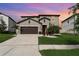 Charming two-story home features a manicured lawn, two-car garage, and inviting entryway at 13532 Palmera Vista Dr, Riverview, FL 33579