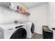 Bright laundry room with modern appliances, ample storage, and stylish tile flooring, combining utility with design at 13532 Palmera Vista Dr, Riverview, FL 33579