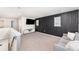 Bright living room with a contemporary black accent wall and plush grey seating at 13532 Palmera Vista Dr, Riverview, FL 33579