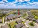 Beautiful aerial view of the property showing mature trees, landscaping and a pond with fountain at 18743 Coastal Shore Ter, Land O Lakes, FL 34638