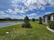 Scenic backyard overlooking a serene pond and lush landscaping, creating a peaceful retreat at 18743 Coastal Shore Ter, Land O Lakes, FL 34638