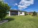 Lush backyard with green lawn, tasteful landscaping, and a screened-in patio at 18743 Coastal Shore Ter, Land O Lakes, FL 34638