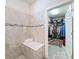 Elegant bathroom featuring a walk-in shower and walk-in closet at 18743 Coastal Shore Ter, Land O Lakes, FL 34638