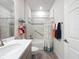 Well-lit bathroom with flamingo shower curtain, large mirror, and combination tub and shower with modern tile at 18743 Coastal Shore Ter, Land O Lakes, FL 34638
