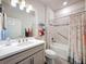 Well-lit bathroom with flamingo shower curtain, large mirror, and combination tub and shower with modern tile at 18743 Coastal Shore Ter, Land O Lakes, FL 34638