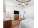 Brightly lit bedroom with wooden ceiling fan, mounted television, wood dresser, and flamingo bedding at 18743 Coastal Shore Ter, Land O Lakes, FL 34638