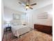 Well-lit bedroom with ceiling fan, queen bed, matching night stands, closet and dresser at 18743 Coastal Shore Ter, Land O Lakes, FL 34638