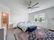 Serene bedroom with a ceiling fan, dresser, and a large window providing plenty of natural light at 18743 Coastal Shore Ter, Land O Lakes, FL 34638