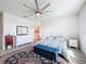 Relaxing bedroom featuring a ceiling fan, a cozy bed, and plenty of natural light from the large window at 18743 Coastal Shore Ter, Land O Lakes, FL 34638