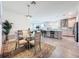 Open concept dining area flowing into a modern kitchen with island seating and stainless steel appliances at 18743 Coastal Shore Ter, Land O Lakes, FL 34638