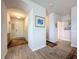 A bright and inviting entryway with wood-look tile floors, an arched ceiling and decorative artwork at 18743 Coastal Shore Ter, Land O Lakes, FL 34638