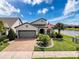 Charming single-Gathering home showcasing manicured landscaping, an inviting entrance, and a two-car garage at 18743 Coastal Shore Ter, Land O Lakes, FL 34638