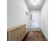 Bright hallway featuring modern light fixtures, neutral paint, and stylish storage furniture at 18743 Coastal Shore Ter, Land O Lakes, FL 34638