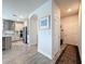 Inviting hallway leading to a modern kitchen with stainless steel appliances and stylish tile flooring at 18743 Coastal Shore Ter, Land O Lakes, FL 34638