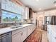 Well-equipped kitchen with stainless steel appliances, tiled backsplash, and ample countertop space at 18743 Coastal Shore Ter, Land O Lakes, FL 34638