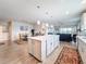 Open concept kitchen with island seating flows into dining and living areas at 18743 Coastal Shore Ter, Land O Lakes, FL 34638